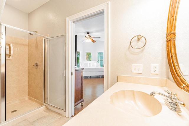 bathroom featuring an enclosed shower, vanity, and ceiling fan