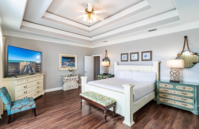 bedroom featuring ceiling fan, crown molding, and a tray ceiling