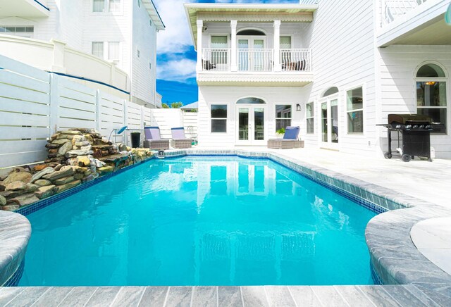 view of pool featuring a patio and a grill