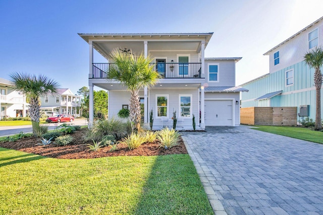 view of front of home with a front lawn, a garage, and a balcony