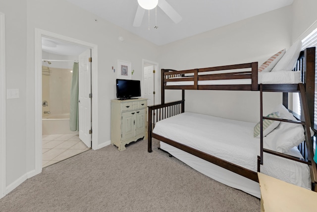 bedroom featuring ensuite bath, ceiling fan, and light tile flooring