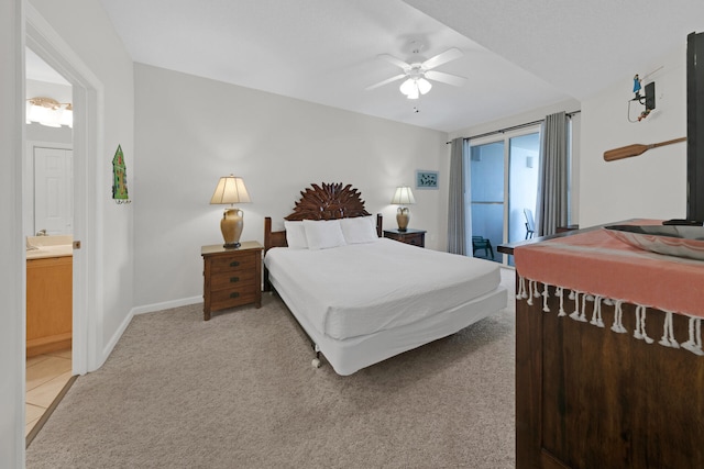 bedroom featuring ceiling fan, ensuite bathroom, and light carpet