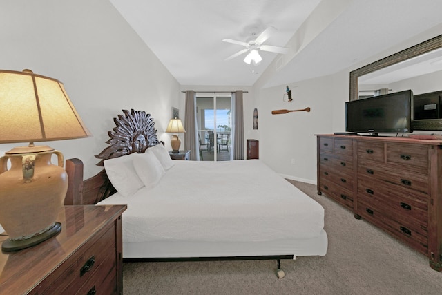 carpeted bedroom with ceiling fan, vaulted ceiling, and access to outside