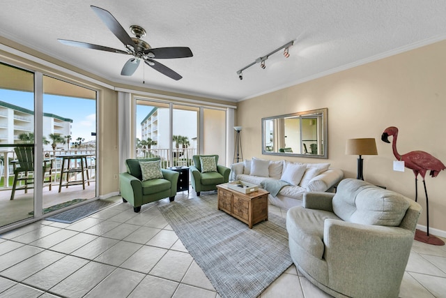 living room with ceiling fan, crown molding, a textured ceiling, rail lighting, and light tile floors