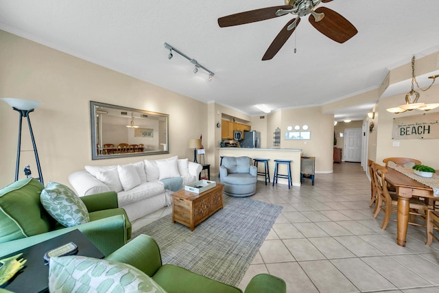 living room with rail lighting, ceiling fan, light tile floors, and ornamental molding