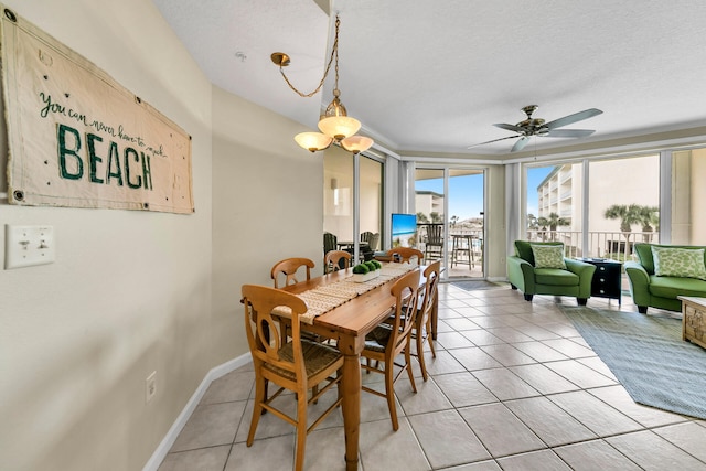 tiled dining space featuring ceiling fan and a textured ceiling