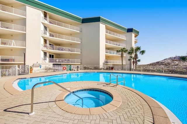 view of pool with a community hot tub