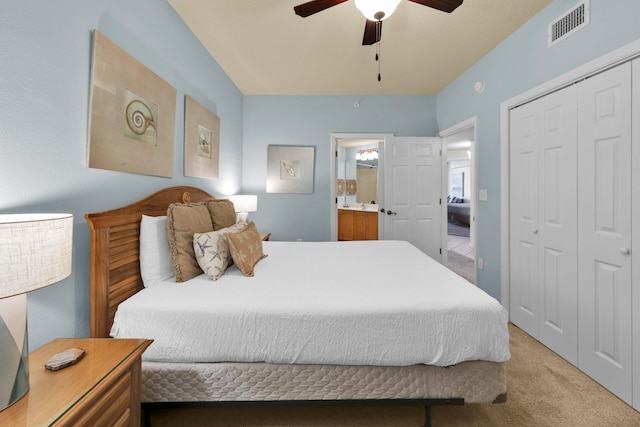 carpeted bedroom featuring a closet, ceiling fan, and connected bathroom