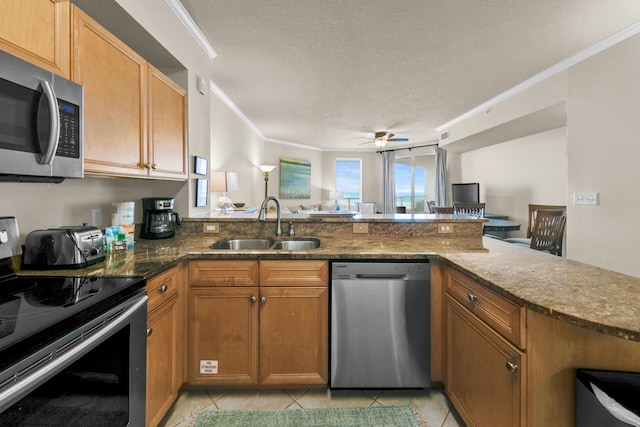 kitchen with ornamental molding, appliances with stainless steel finishes, kitchen peninsula, and light tile floors