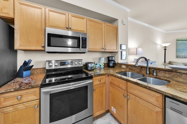 kitchen with stainless steel appliances, dark stone countertops, sink, light tile floors, and ornamental molding