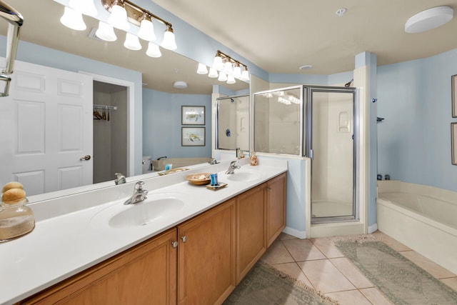 bathroom featuring double sink, tile floors, oversized vanity, and independent shower and bath