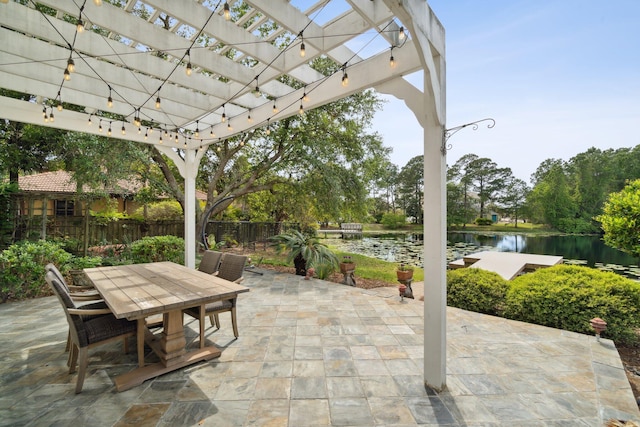 view of terrace with a pergola and a water view