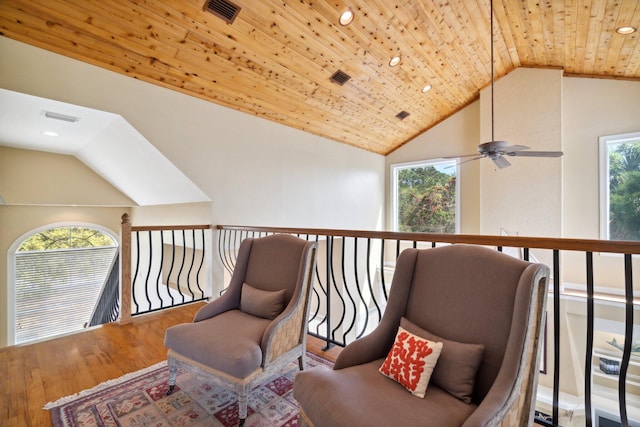 sitting room with wood ceiling, vaulted ceiling, hardwood / wood-style floors, and ceiling fan