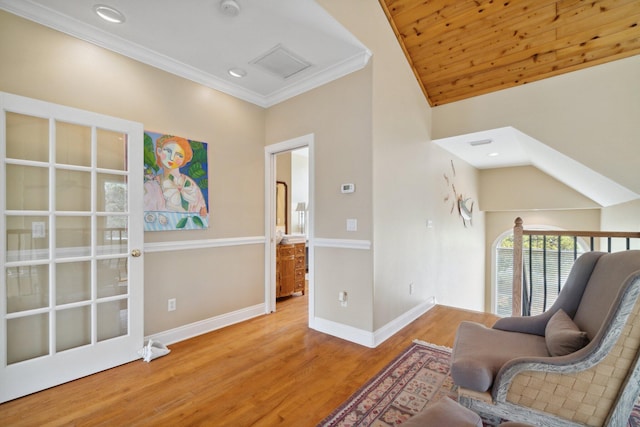 living area featuring lofted ceiling, crown molding, light wood-type flooring, and wooden ceiling