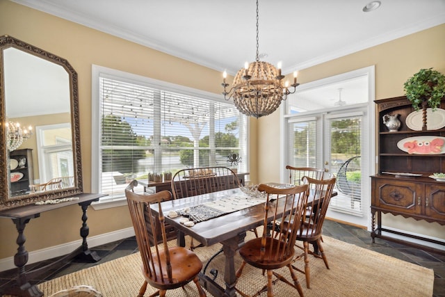 dining area featuring plenty of natural light, a notable chandelier, and crown molding