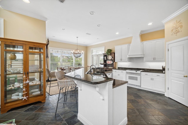 kitchen with a kitchen bar, premium range hood, hanging light fixtures, electric range, and white cabinetry