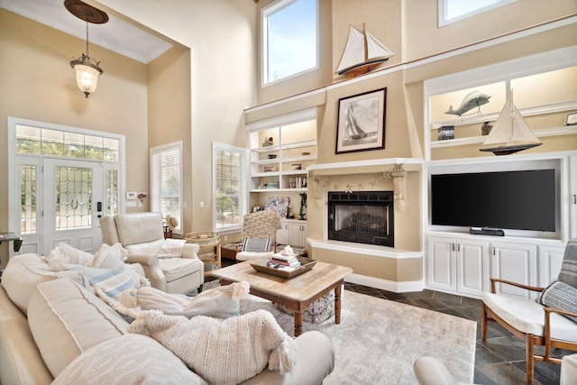 living room featuring plenty of natural light, built in shelves, a high ceiling, and dark parquet floors