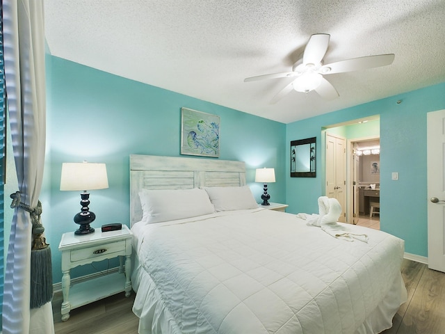 bedroom featuring hardwood / wood-style floors, ceiling fan, ensuite bathroom, and a textured ceiling