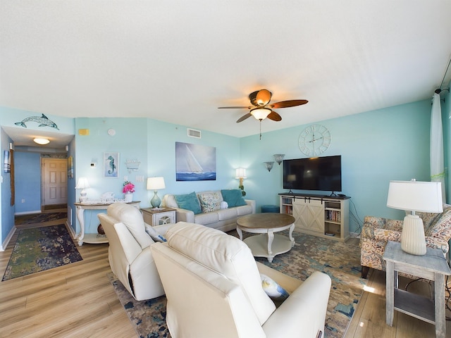 living room featuring light hardwood / wood-style floors and ceiling fan