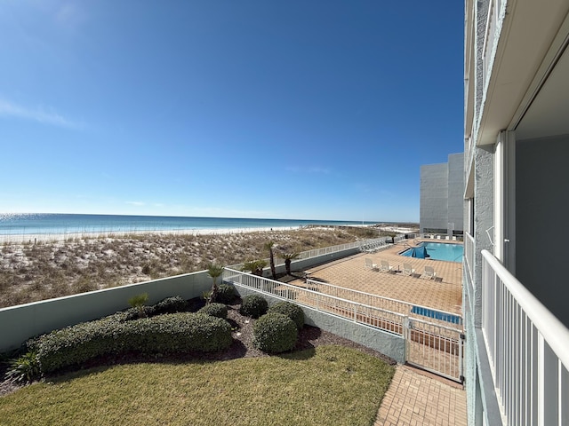 balcony featuring a beach view and a water view