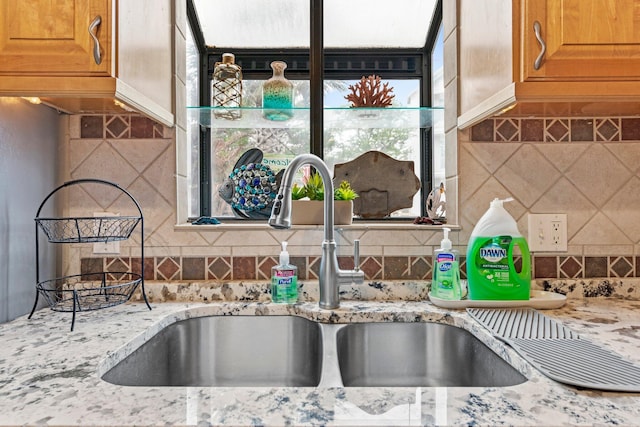 interior details featuring backsplash and sink