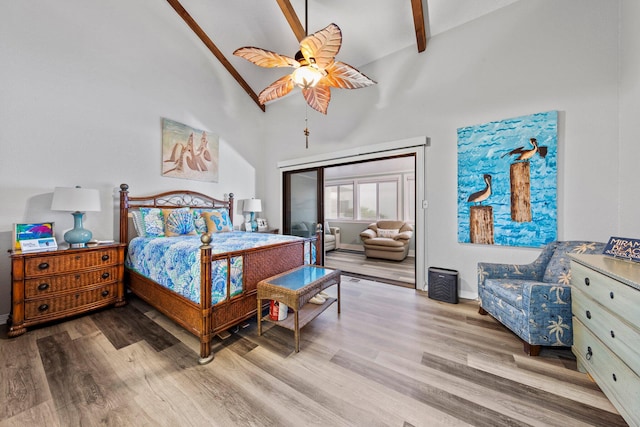 bedroom featuring high vaulted ceiling, light hardwood / wood-style floors, beam ceiling, and ceiling fan