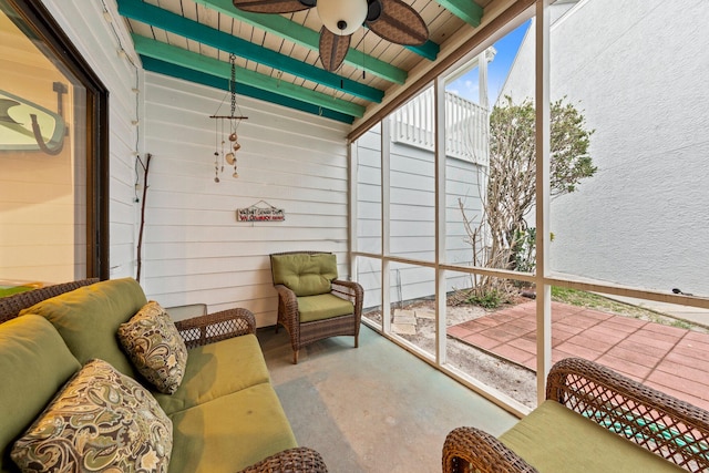 sunroom with beamed ceiling and ceiling fan