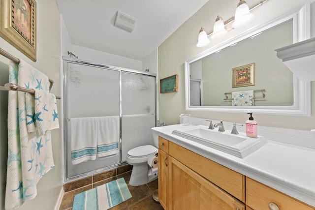 bathroom with tile flooring, walk in shower, vanity, and toilet