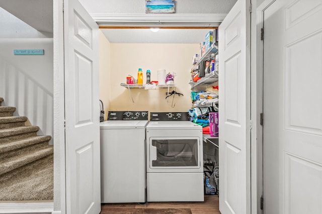 washroom with hardwood / wood-style flooring and washer and dryer