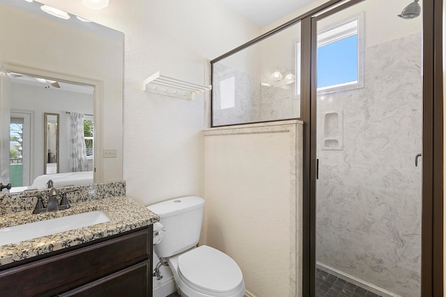 bathroom featuring a shower with door, oversized vanity, tile floors, and toilet