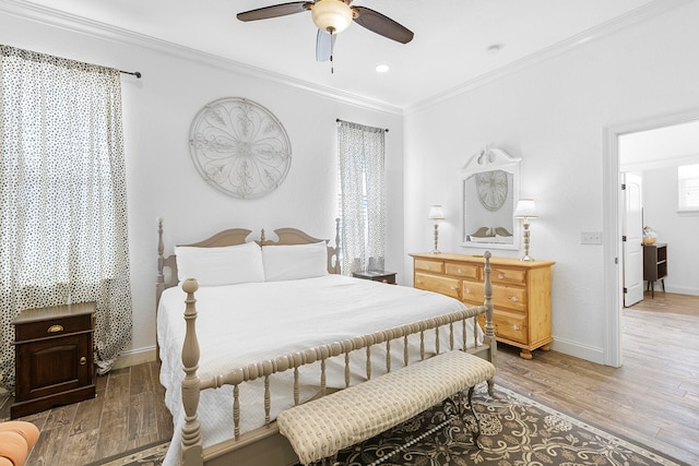 bedroom featuring ceiling fan, hardwood / wood-style flooring, and ornamental molding