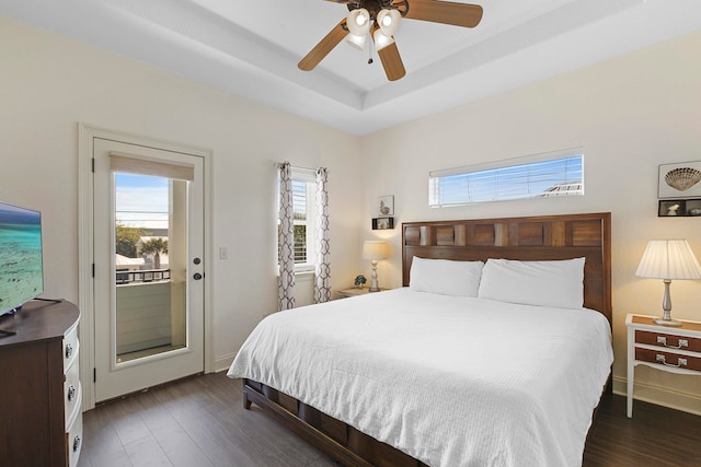 bedroom featuring dark wood-type flooring, ceiling fan, and multiple windows