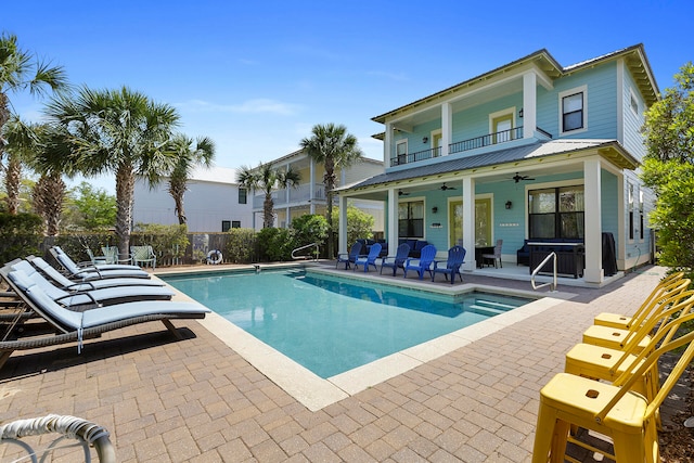 view of pool with a patio area and ceiling fan