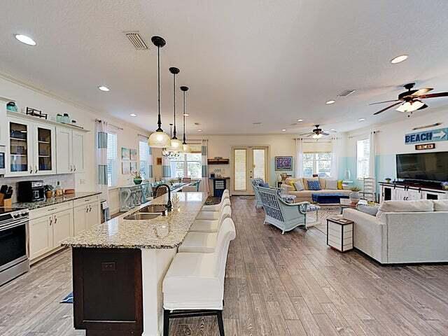 kitchen with white cabinets, sink, pendant lighting, and a breakfast bar area