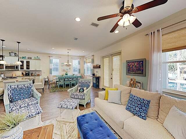 living room with wood-type flooring, plenty of natural light, french doors, and ceiling fan