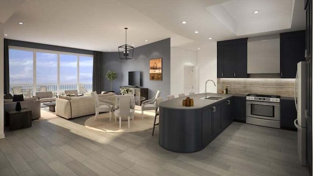 kitchen with tasteful backsplash, stainless steel gas stove, floor to ceiling windows, light hardwood / wood-style flooring, and kitchen peninsula