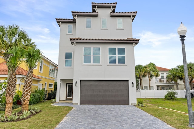 mediterranean / spanish-style home with a garage and a front yard