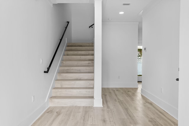 staircase with light hardwood / wood-style floors