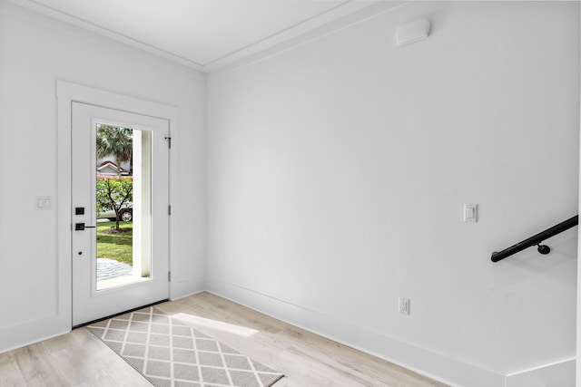 entryway featuring crown molding and light hardwood / wood-style flooring