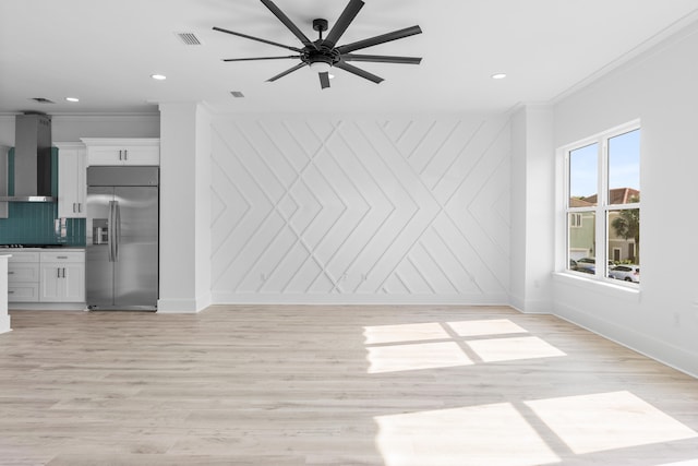 spare room with ceiling fan, light hardwood / wood-style floors, and crown molding