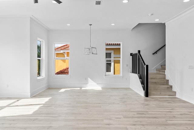 entrance foyer featuring ornamental molding, ceiling fan, and light wood-type flooring