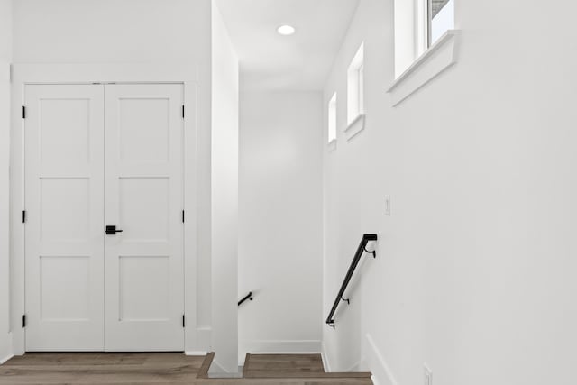 stairway featuring light hardwood / wood-style floors