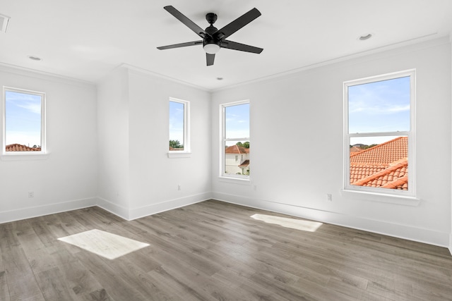 unfurnished room featuring light hardwood / wood-style flooring, ceiling fan, and crown molding