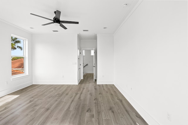 empty room featuring light hardwood / wood-style flooring, ceiling fan, and ornamental molding