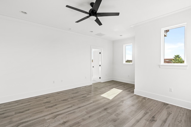 empty room with ceiling fan, crown molding, and dark hardwood / wood-style flooring