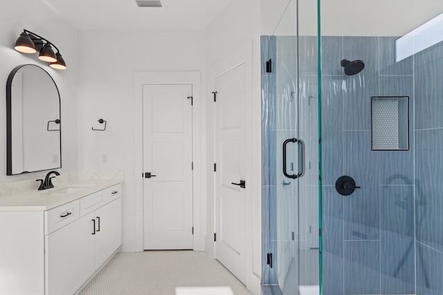 bathroom with tile flooring, walk in shower, and oversized vanity