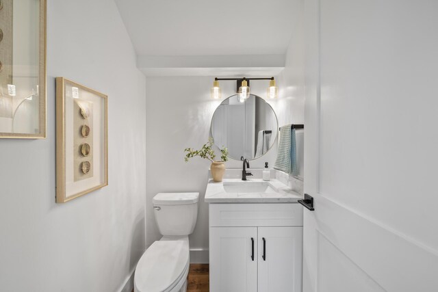 bathroom featuring hardwood / wood-style floors, vanity, and toilet