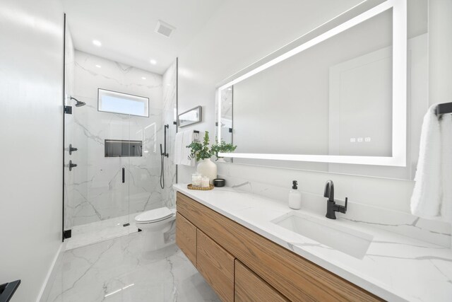 bathroom with a shower with shower door, vanity, and toilet