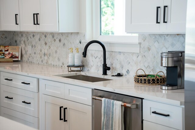 kitchen featuring dishwasher, light stone counters, white cabinetry, and tasteful backsplash