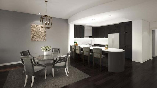 dining area featuring sink, dark wood-type flooring, and a notable chandelier